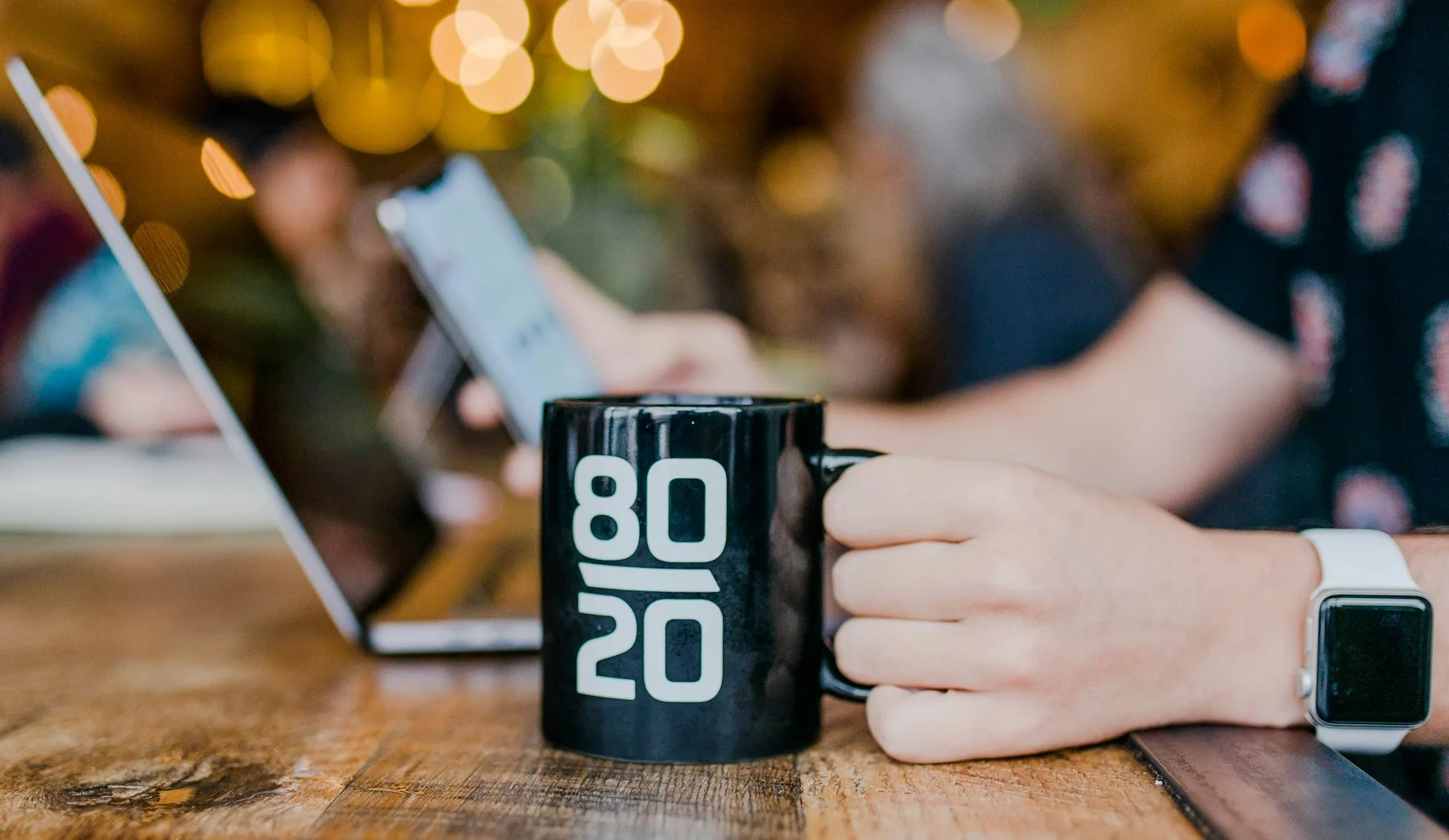 A small business owner working from a cafe table